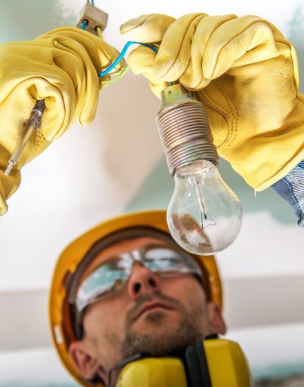 Electrician Checking Cables in a Lighting System to Fix a Bug